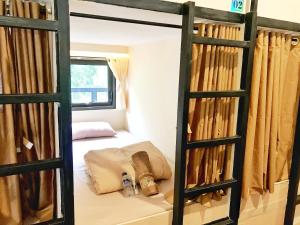 a bedroom with a bunk bed with a window at Bromo Dormitory & Camp in Bromo