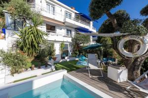 a villa with a swimming pool and a house at Villa Iris in Nice