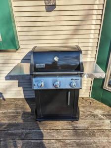 a grill is sitting outside of a house at Secluded Oasis on Acadia's Quietside - Pets OK! in Southwest Harbor