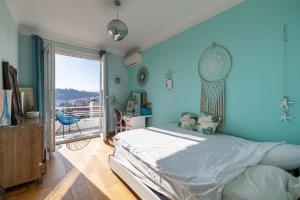 a blue bedroom with a bed and a balcony at Villa Iris in Nice