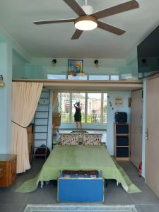 a bedroom with a bed and a ceiling fan at Acropolis Panoramic Studio in Athens