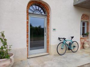 a bike parked in front of a door at Bed and Breakfast Caplin in Mondovì
