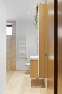 a bathroom with a sink and a toilet and a tub at City Heart Retreat Elegant Apartment in Bucharest