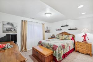 a bedroom with a bed and a dresser and a television at Cozy American Fork Retreat with Electric Fireplace in American Fork