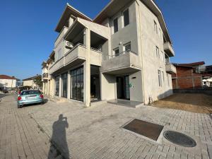 a shadow of a person taking a picture of a building at Lumi Apartments in Gevgelija