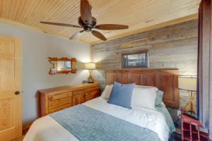 a bedroom with a bed and a ceiling fan at Lakefront Cottage with Deck Near Indiana Beach! in Monticello