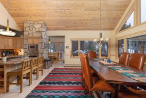 a kitchen and dining room with a wooden table and chairs at Happy Trails Lodge in Breckenridge