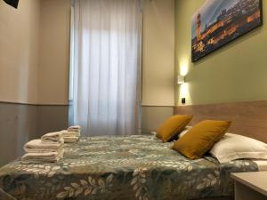 Postel nebo postele na pokoji v ubytování Hotel Camilla Guelfa