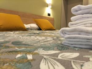 Postel nebo postele na pokoji v ubytování Hotel Camilla Guelfa