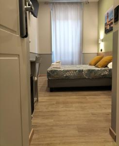 Postel nebo postele na pokoji v ubytování Hotel Camilla Guelfa