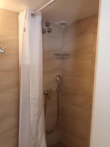 a shower with a shower curtain in a bathroom at Tenok Boutique Home in Tinos +5 photos
