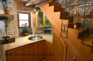 a kitchen with a sink and a stair in a room at Vila Nada Piran in Piran