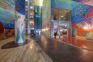 a hallway in a building with a mural on the wall at Sesimbra Oceanfront Hotel - Preferred Hotels and Resorts in Sesimbra