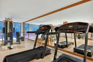 a gym with treadmills and elliptical machines at Sesimbra Oceanfront Hotel - Preferred Hotels and Resorts in Sesimbra