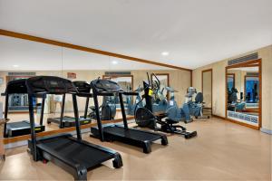 a gym with several treadmills and elliptical machines at Sesimbra Oceanfront Hotel - Preferred Hotels and Resorts in Sesimbra