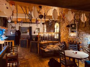 a living room with a couch and a stone wall at The Welshman’s Arms in Pembroke Dock