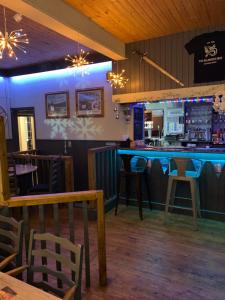 a bar in a restaurant with a counter and chairs at The Welshman’s Arms in Pembrokeshire