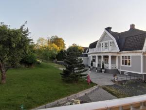 an aerial view of a white house with a yard at Bergland apartment 23 - close to the center of Kragerø in Kragerø