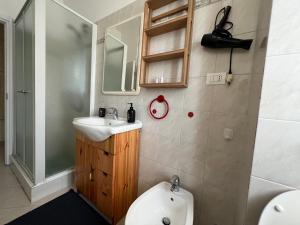 a bathroom with a sink and a toilet and a mirror at Stazione a 400 metriTeds Home in Melegnano