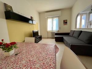 a living room with a couch and a table at Stazione a 400 metriTeds Home in Melegnano