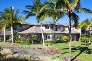 a house with palm trees in front of it at Kulalani at Mauna Lani 802 in Waikoloa