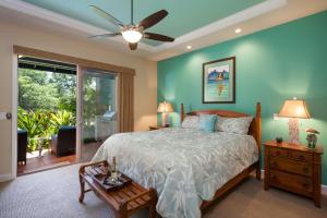 a bedroom with a bed and a ceiling fan at Kulalani at Mauna Lani 802 in Waikoloa +28 photos