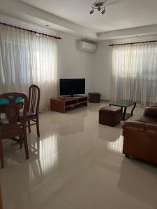 a living room with a tv and a couch and a table at Alojamento dos Redondos in Fernao Ferro