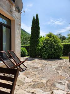 a pair of chairs sitting on a stone patio at Eco Residence in Ribarica