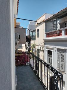 a balcony of a building with a black railing at Tenok Boutique Home in Tinos