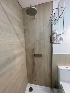 a bathroom with a shower with a toilet at Blue House in Costa da Caparica