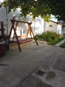 a wooden swing set sitting in a yard at Casa Roxy in Cristian