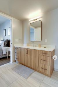 a bathroom with a sink and a mirror at Stylish Condo at Clarendon with Rooftop Views in Arlington