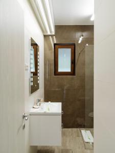 a bathroom with a sink and a shower at Nature Loft by the river in Buşteni +36 photos