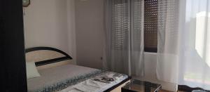a small bedroom with a bed and a window at Julija Guest House in Ohrid