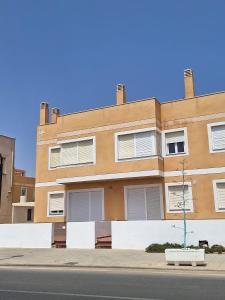 a building on the side of a street at Apartamentos La Calilla Cabo de Gata in El Cabo de Gata