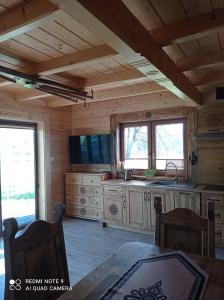 a kitchen in a log cabin with a table at Domki ,,Goramiba'' in Jurgów