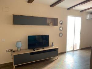 a living room with a flat screen tv on a wall at La Andana in Macastre