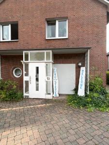 a garage with a white door and a brick building at Fewo an der Stever in Lüdinghausen