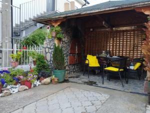 a patio with a table and chairs and plants at Dana in Trnava