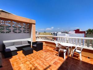 a balcony with a table and chairs on a roof at Playa Paradís - Primera linea de playa - AP-7 3min - Self check-in 24h in Moncófar