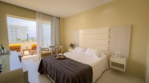 a hotel room with a bed and a balcony at Tasia Maris Beach Hotel - Adults Only in Ayia Napa