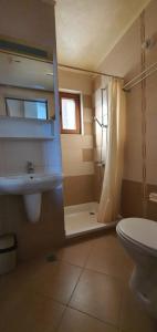 a bathroom with a sink and a shower and a toilet at Villa Una 7C in Lozenets