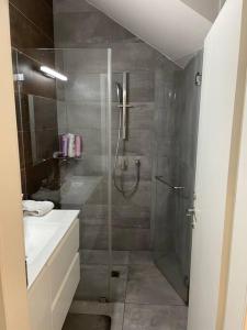 a bathroom with a shower and a sink at יוקרה בגליל in Biriyya
