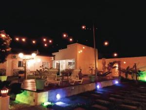 a house with a patio at night with lights at Recanto Dos Lençóis in Barreirinhas