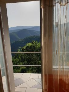 a window with a view of a mountain view at Vila Fantastico in Skopje