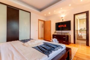 a bedroom with a bed and a mirror and a keyboard at 1BR Apt with Jacuzzi near Herastrau: Ideal Getaway in Bucharest