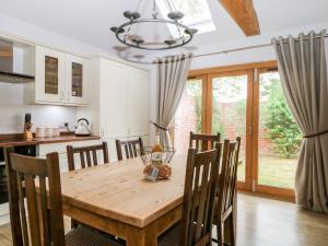 a kitchen and dining room with a wooden table and chairs at Squirrels Drey in Fareham