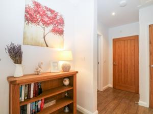 a room with a book shelf and a painting on the wall at Squirrels Drey in Fareham