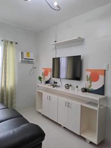 ein Wohnzimmer mit Fernseher und Sofa in der Unterkunft Camella Manor Majorca in Bacolod City