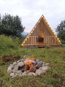 a fire pit in front of a log cabin at AMOJ B&B and Guest house in Alaverdi